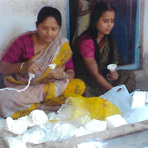 Women engaged in making shola crafts for sale