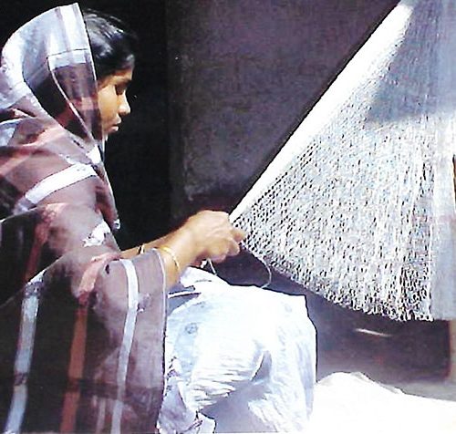 Woman weaving a fishing net